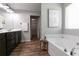 Bright bathroom features a soaking tub, updated fixtures, and a linen closet at 3894 Dunaire Dr, Stone Mountain, GA 30083
