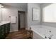 Bathroom featuring a soaking tub, updated fixtures, and a linen closet at 3894 Dunaire Dr, Stone Mountain, GA 30083