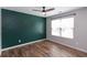 Bedroom featuring an accent wall, window and wood-look flooring at 3894 Dunaire Dr, Stone Mountain, GA 30083