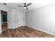 Bedroom with a ceiling fan, two closets, and wood-look flooring at 3894 Dunaire Dr, Stone Mountain, GA 30083
