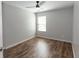 Bedroom featuring a ceiling fan, a window, and wood-look flooring at 3894 Dunaire Dr, Stone Mountain, GA 30083