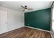 Bedroom boasts modern accent wall, ceiling fan, and hardwood floors at 3894 Dunaire Dr, Stone Mountain, GA 30083