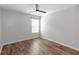 Bedroom with a ceiling fan, window, and wood-look flooring at 3894 Dunaire Dr, Stone Mountain, GA 30083