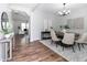 Open-concept dining area with stylish furnishings, light-colored walls, and wood flooring at 3894 Dunaire Dr, Stone Mountain, GA 30083
