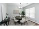 Bright dining room with a round table, modern light fixture, and stylish decor at 3894 Dunaire Dr, Stone Mountain, GA 30083