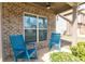 Charming front porch with two blue rocking chairs and brick exterior at 3894 Dunaire Dr, Stone Mountain, GA 30083