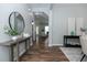 Inviting hallway with wood floors, a console table, decorative mirror, and neutral paint at 3894 Dunaire Dr, Stone Mountain, GA 30083