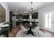Eat-in kitchen with dark cabinets, stainless appliances, and a doorway to the exterior at 3894 Dunaire Dr, Stone Mountain, GA 30083