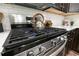 Close-up of gas range in kitchen featuring stainless steel appliances and white countertop at 3894 Dunaire Dr, Stone Mountain, GA 30083