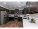 Spacious kitchen with dark wood cabinets, stainless steel appliances and white subway tile backsplash at 3894 Dunaire Dr, Stone Mountain, GA 30083