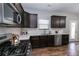 Stylish kitchen featuring stainless steel appliances, dark cabinetry and tiled backsplash at 3894 Dunaire Dr, Stone Mountain, GA 30083