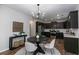 Cozy eat-in kitchen with stylish chandelier, stainless steel appliances, and dark cabinets at 3894 Dunaire Dr, Stone Mountain, GA 30083