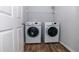 Convenient laundry room area featuring white washer and dryer units with wood-look flooring at 3894 Dunaire Dr, Stone Mountain, GA 30083