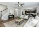 Open-concept living room showing stairs to the left and eat-in kitchen in the background at 3894 Dunaire Dr, Stone Mountain, GA 30083