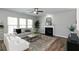 Bright living room with a fireplace, ceiling fan, and large windows allowing natural light at 3894 Dunaire Dr, Stone Mountain, GA 30083