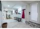 Well-lit basement entry with built-in bench, coat hooks, and stylish tiled flooring providing a welcoming transition at 417 Lynnhaven Sw Dr, Atlanta, GA 30310