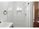 Modern bathroom with white tiled shower, niche, and vanity with round faucet and fixtures at 417 Lynnhaven Sw Dr, Atlanta, GA 30310