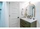 Stylish bathroom with a vanity, a decorative mirror, and a tiled shower at 417 Lynnhaven Sw Dr, Atlanta, GA 30310