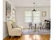 View of the bright dining area with decor and seating near large windows and natural light at 417 Lynnhaven Sw Dr, Atlanta, GA 30310