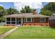 Charming red brick home with a cozy screened-in porch and well-manicured lawn at 417 Lynnhaven Sw Dr, Atlanta, GA 30310