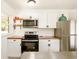 A view of the kitchen with white cabinets, wood counters, and stainless steel appliances at 417 Lynnhaven Sw Dr, Atlanta, GA 30310