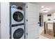 Laundry area with stacked washer and dryer next to kitchen and dining at 417 Lynnhaven Sw Dr, Atlanta, GA 30310