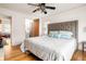 View of the main bedroom showcasing a plush bed with decor, ceiling fan, and hardwood floors at 417 Lynnhaven Sw Dr, Atlanta, GA 30310