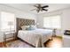 A well-lit bedroom with a tufted headboard and neutral bedding and decor at 417 Lynnhaven Sw Dr, Atlanta, GA 30310