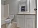 Cozy bathroom featuring a tiled floor, white cabinet, and a framed mirror at 5987 Turfway Park Ct, Sugar Hill, GA 30518