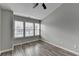 Inviting bedroom featuring hardwood floors and three bright windows at 5987 Turfway Park Ct, Sugar Hill, GA 30518