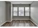 Bright bedroom with hardwood floors and three large windows at 5987 Turfway Park Ct, Sugar Hill, GA 30518