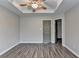 Cozy bedroom with wood floors and doors leading to closet and bathroom at 5987 Turfway Park Ct, Sugar Hill, GA 30518