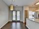 Cozy dining area with wood flooring, double doors and modern light fixture at 5987 Turfway Park Ct, Sugar Hill, GA 30518