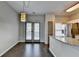 Cozy dining area with wood flooring, double doors and modern light fixture at 5987 Turfway Park Ct, Sugar Hill, GA 30518