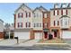 Charming townhome featuring brick accents, neutral siding, and a convenient attached two-car garage at 5987 Turfway Park Ct, Sugar Hill, GA 30518
