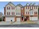 Inviting townhome with classic architectural details, red shutters, and a convenient two-car garage at 5987 Turfway Park Ct, Sugar Hill, GA 30518
