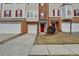 Attractive townhome showcasing brick accents, well-kept landscaping, and a convenient garage at 5987 Turfway Park Ct, Sugar Hill, GA 30518