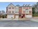 Attractive townhome with red shutters, brick accents, and attached garage at 5987 Turfway Park Ct, Sugar Hill, GA 30518