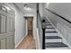 Hallway with tile floor, a staircase, and neutral paint at 5987 Turfway Park Ct, Sugar Hill, GA 30518