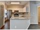 Well-lit kitchen features stainless steel appliances, granite countertops, and white cabinetry at 5987 Turfway Park Ct, Sugar Hill, GA 30518