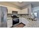 Modern kitchen with stainless steel appliances, granite countertops, and tile backsplash at 5987 Turfway Park Ct, Sugar Hill, GA 30518