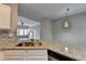 Kitchen area with stone countertops and view into living area at 5987 Turfway Park Ct, Sugar Hill, GA 30518