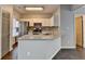 Bright eat-in kitchen featuring white cabinets, tile backsplash, and granite counters at 5987 Turfway Park Ct, Sugar Hill, GA 30518