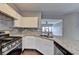 Bright kitchen featuring stainless appliances, stone countertops, and white cabinets at 5987 Turfway Park Ct, Sugar Hill, GA 30518