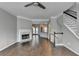 Cozy living room with fireplace, tile floors, and staircase at 5987 Turfway Park Ct, Sugar Hill, GA 30518