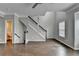 Spacious living room features wood-look floors, staircase, and a bright window at 5987 Turfway Park Ct, Sugar Hill, GA 30518