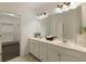 Bathroom featuring a double vanity, large mirror, and linen storage at 1962 Bainbridge Ln, Atlanta, GA 30345