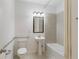 Bright bathroom featuring a pedestal sink, updated tile surround, and a shower-tub combo at 1962 Bainbridge Ln, Atlanta, GA 30345