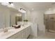 Bright bathroom features a double vanity and a glass shower enclosure at 1962 Bainbridge Ln, Atlanta, GA 30345