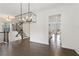 Open concept dining room with hardwood floors, modern lighting, and a view of the staircase at 1962 Bainbridge Ln, Atlanta, GA 30345